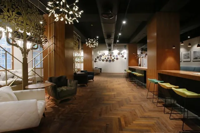 Warm timber lounge with sculptural tree installation and bar seating