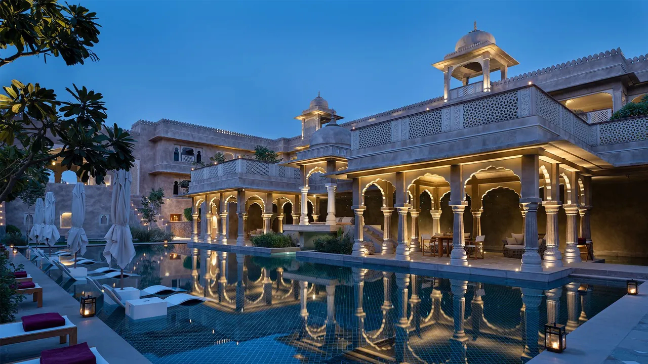 Palace courtyard arcade lit warmly at night