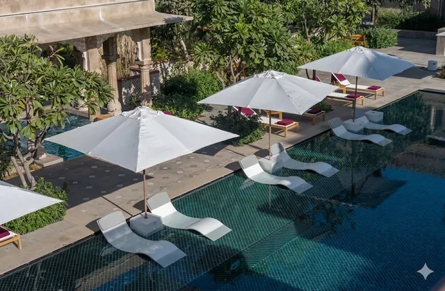 Terrace with white umbrellas beside a turquoise pool