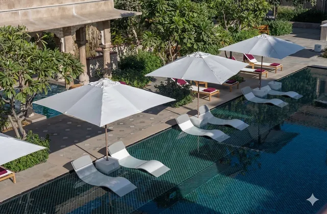 Poolside loungers and white umbrellas seen from above