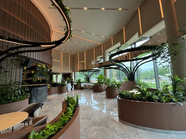 Sales gallery atrium with sculpted planters and sweeping ceiling rings
