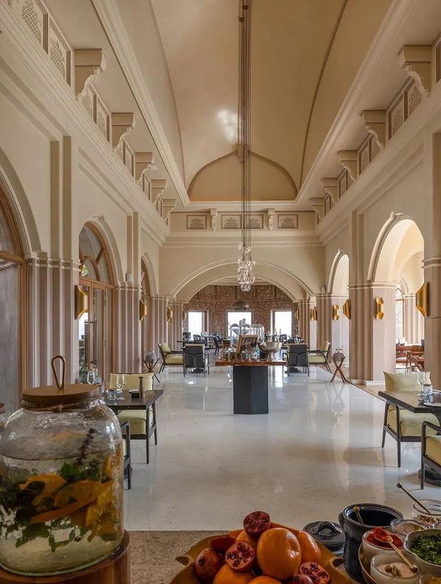 Vaulted heritage hall with polished stone floor and arched ceiling